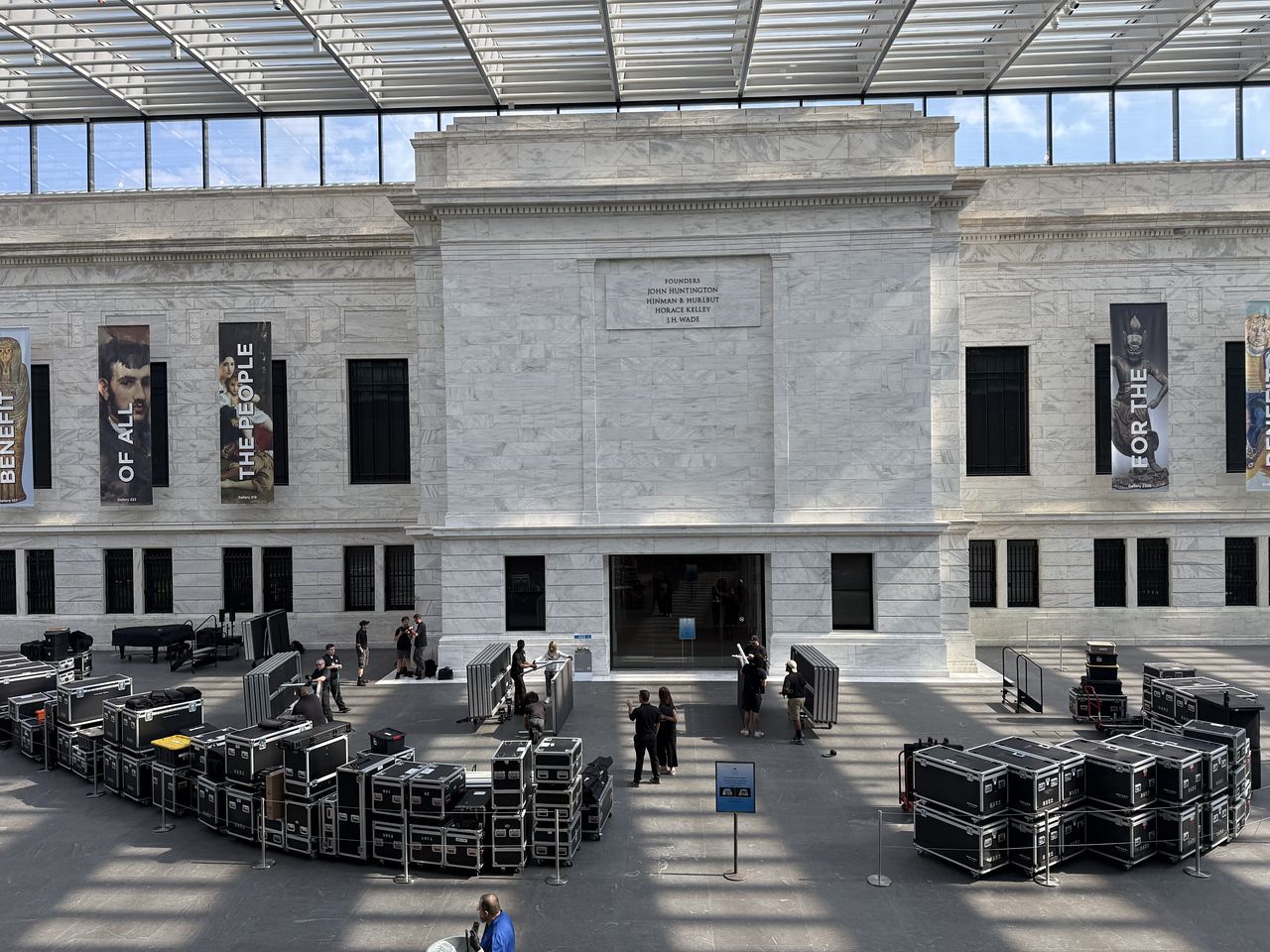 Rows of road cases and staging decks filling the Cleveland Museum of Art atrium on load-in day